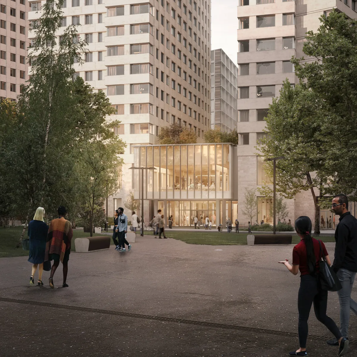 Image shows people in front of a glass fronted building. Large towers are next to and behind.