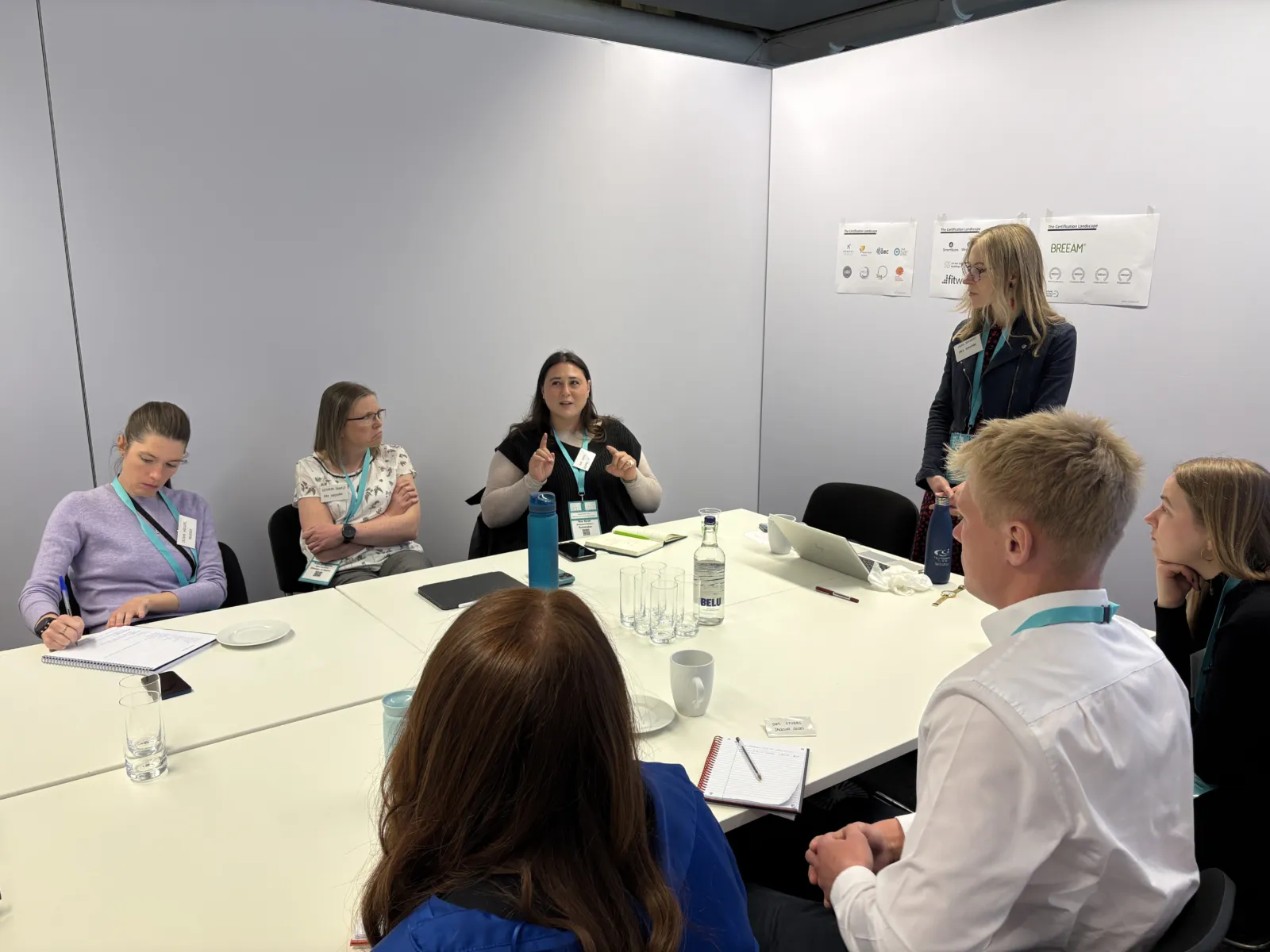 People having a discussion around a desk in a private meeting room