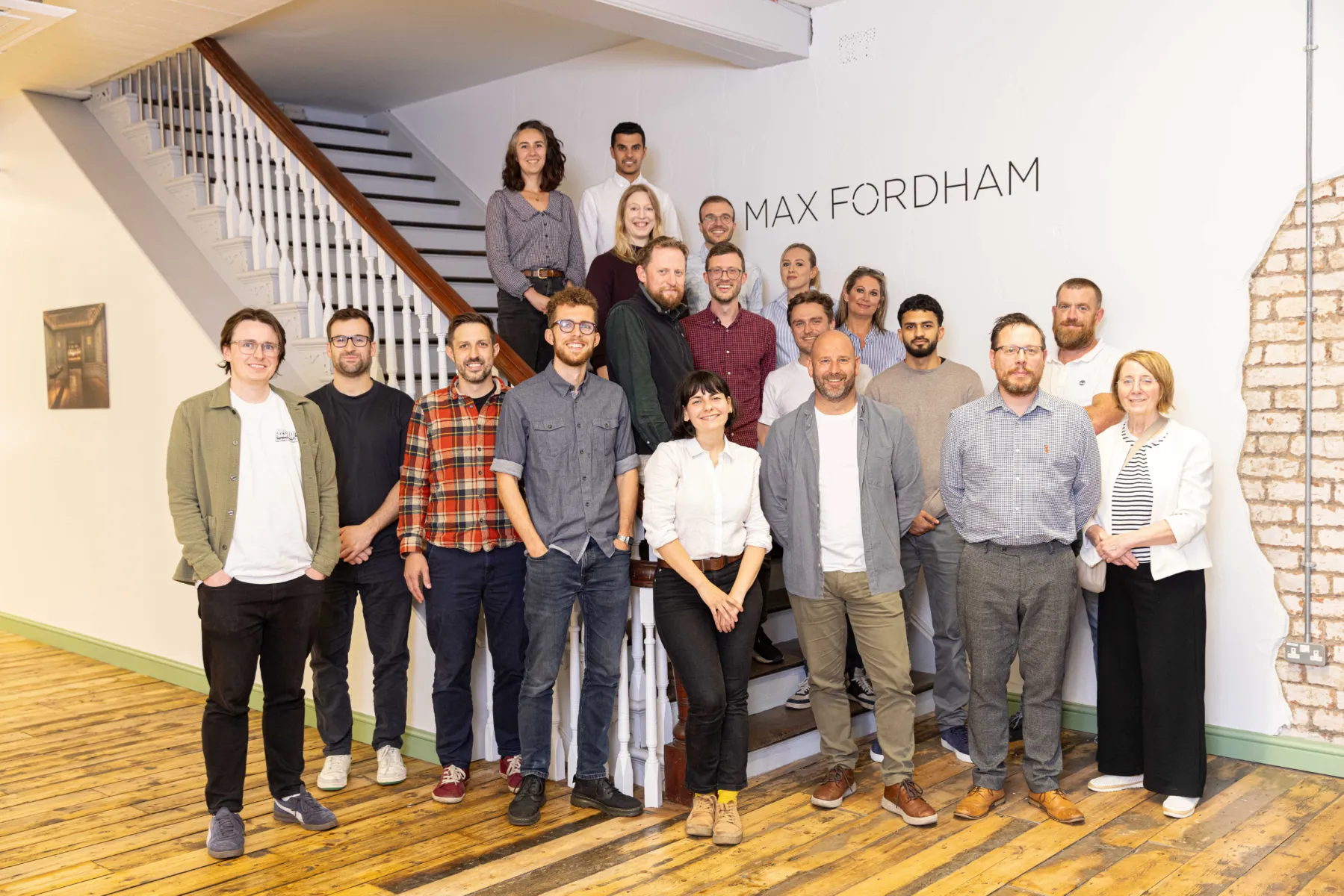 Photo of the whole Manchester office team inside their office in the Cottonpolis Building