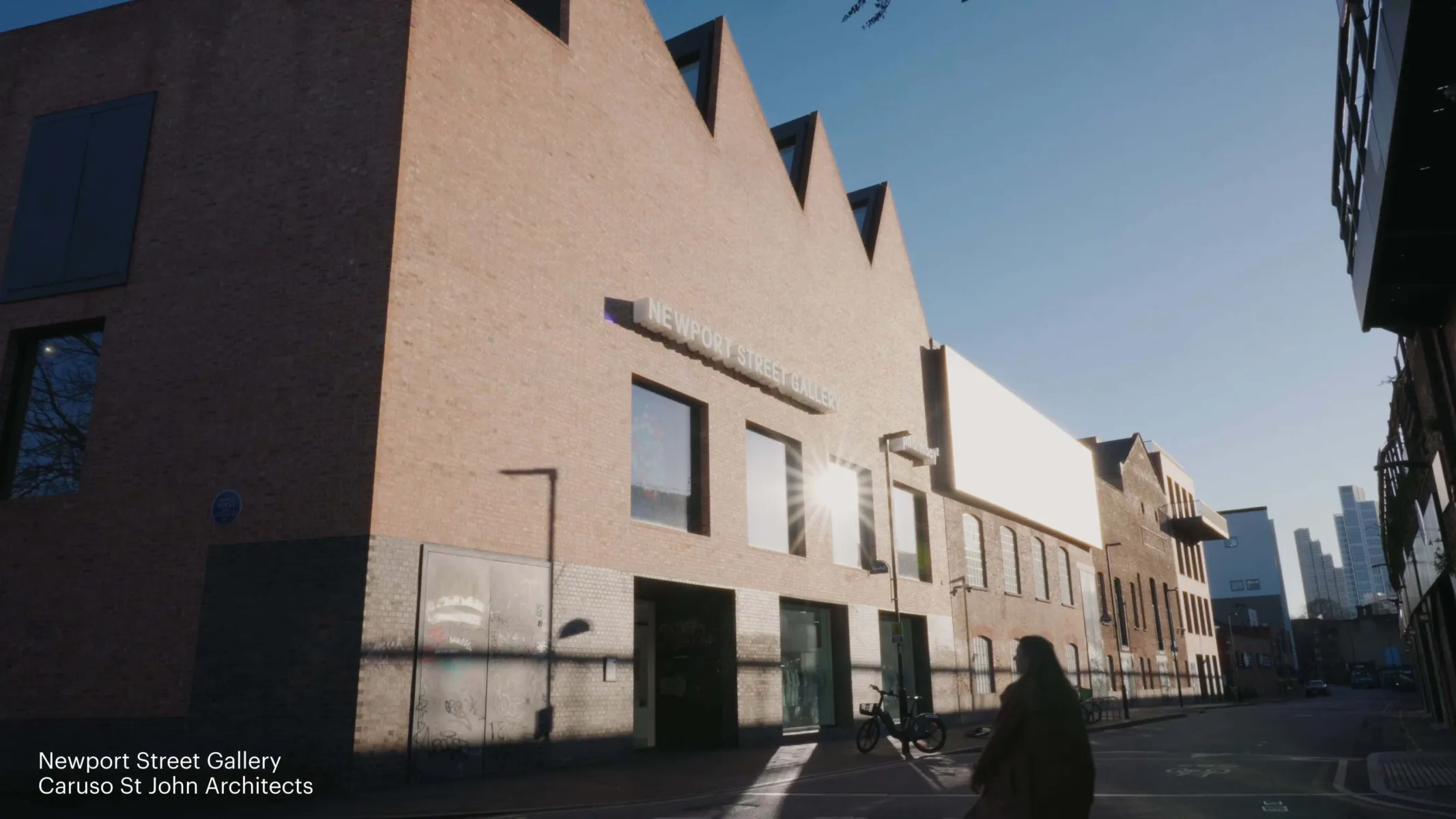 A woman crossing the road towards Newport Street Gallery