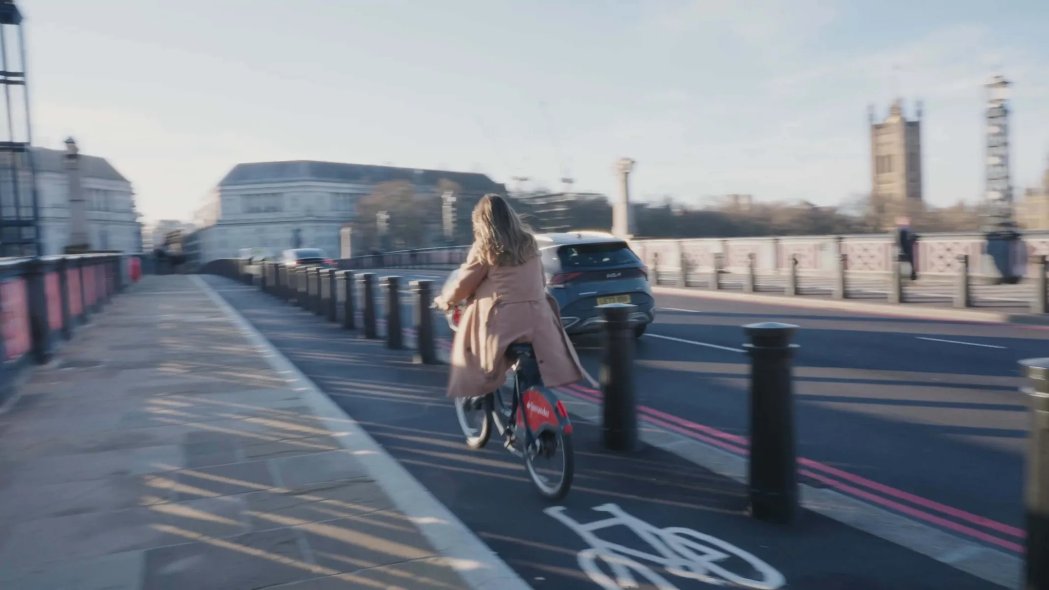 Woman riding a bike over a bridge