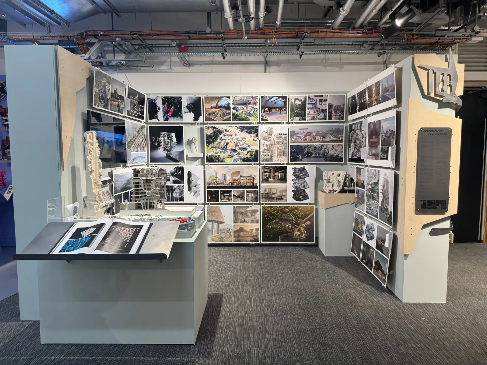 Architecture exhibition displaying concept models, drawings, photographs and digital media related to a large infrastructure project.