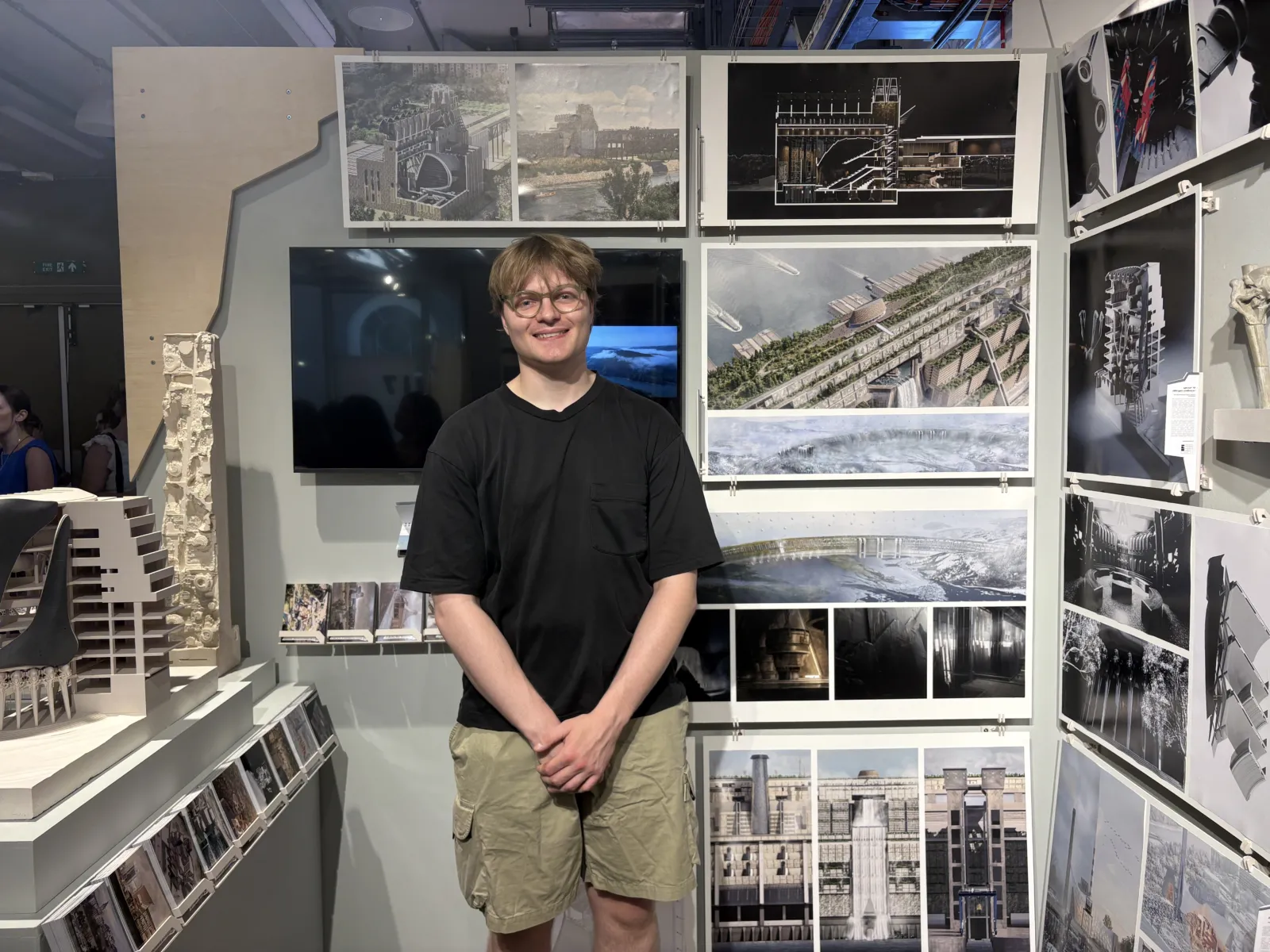 Oliver in front of his project on display at the Summer Show exhibition