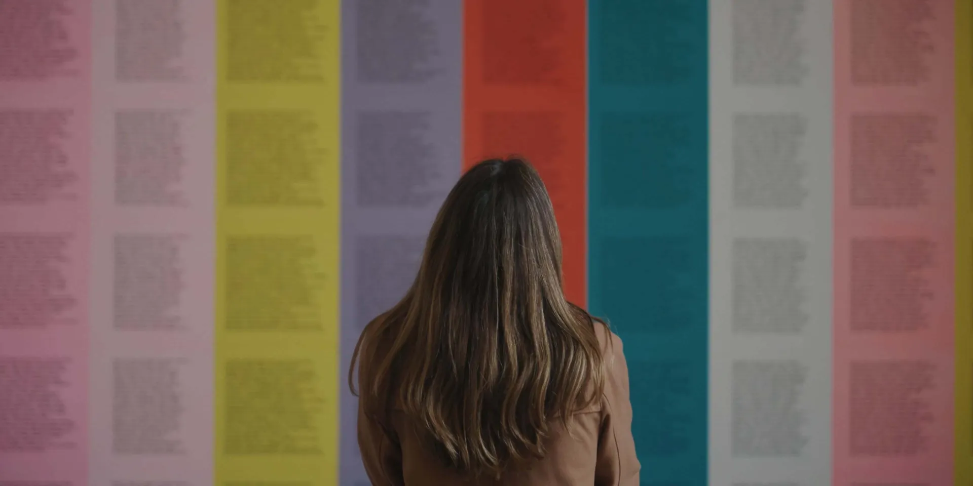Woman looking at colour art posters