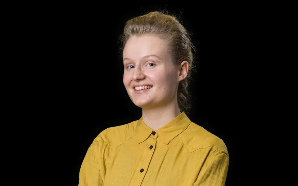A headshot of Brooke Smith wearing a yellow blouse