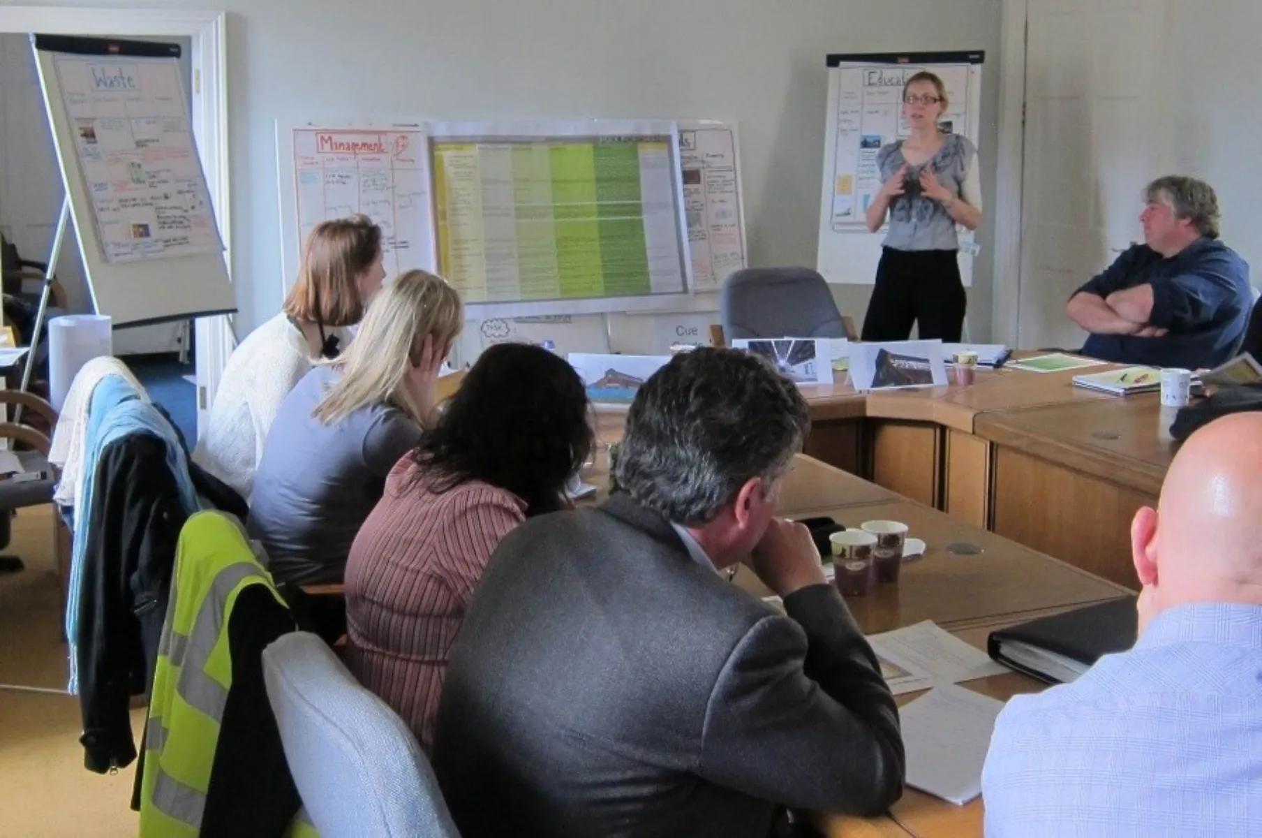 A woman presenting in front of a group of people