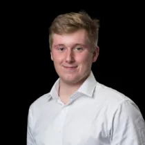 A headshot of Iain Nethercote wearing a white shirt